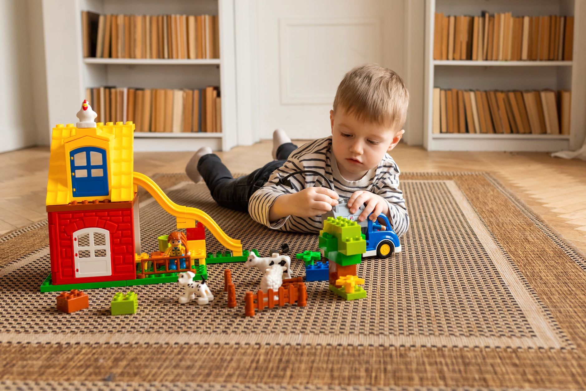 Child playing with colorful toys during a learning activity